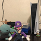 a photo of the playstation 5 next to waluigi baby yoda and kk slider
